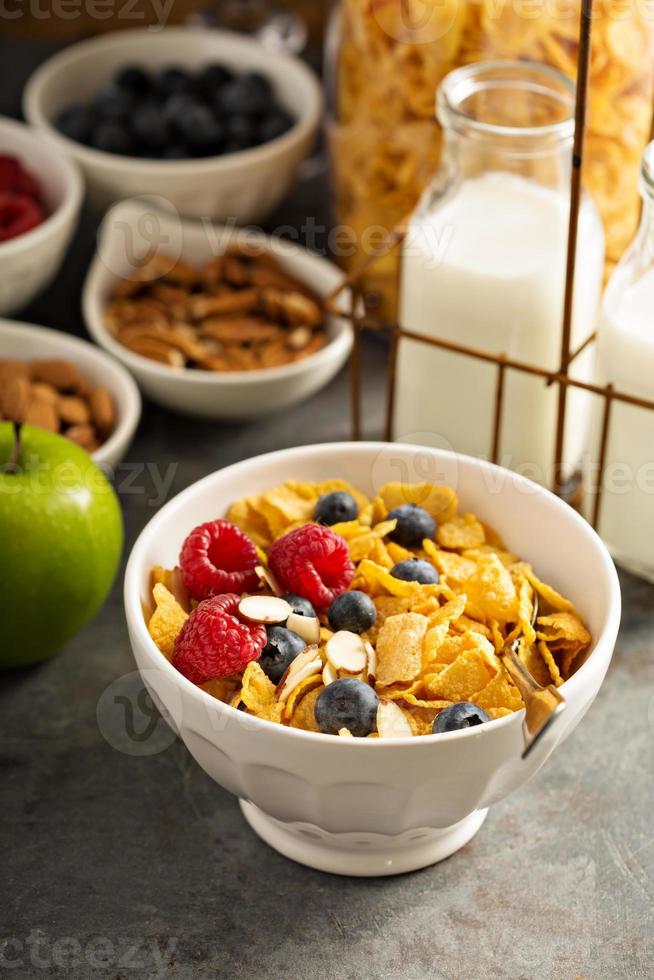 Cereal bar or buffet wih cornflakes, fruit and nuts photo