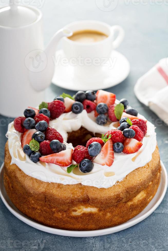 Angel food cake with whipped cream and berries photo