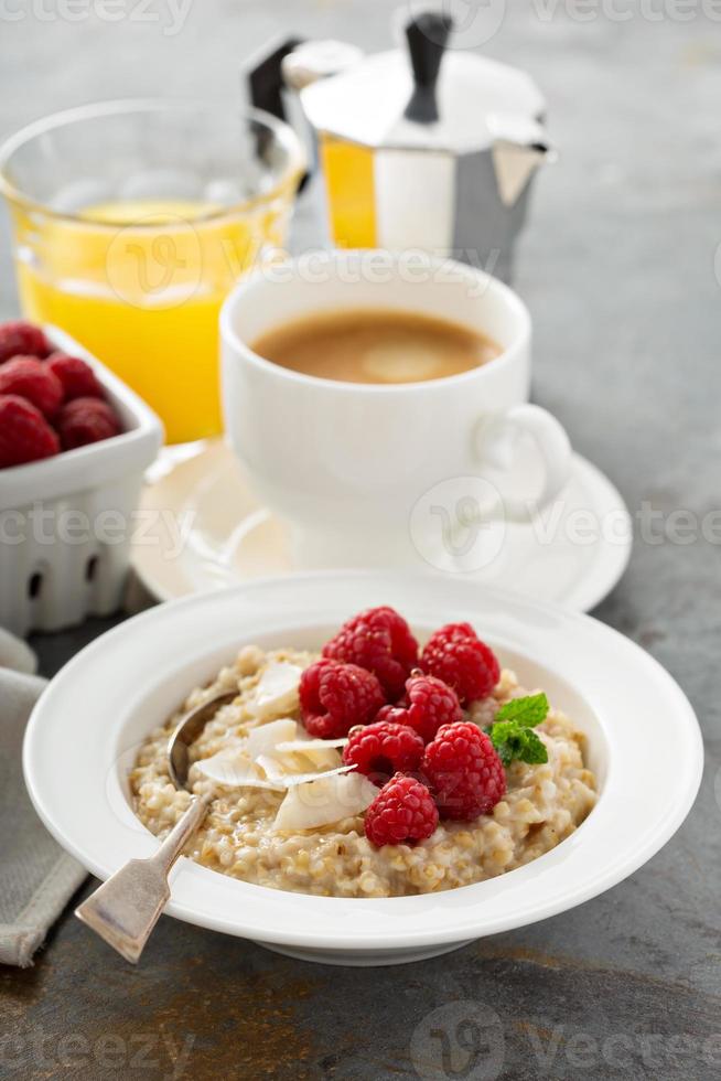 Steel cut oatmeal porridge with raspberry and coconut photo