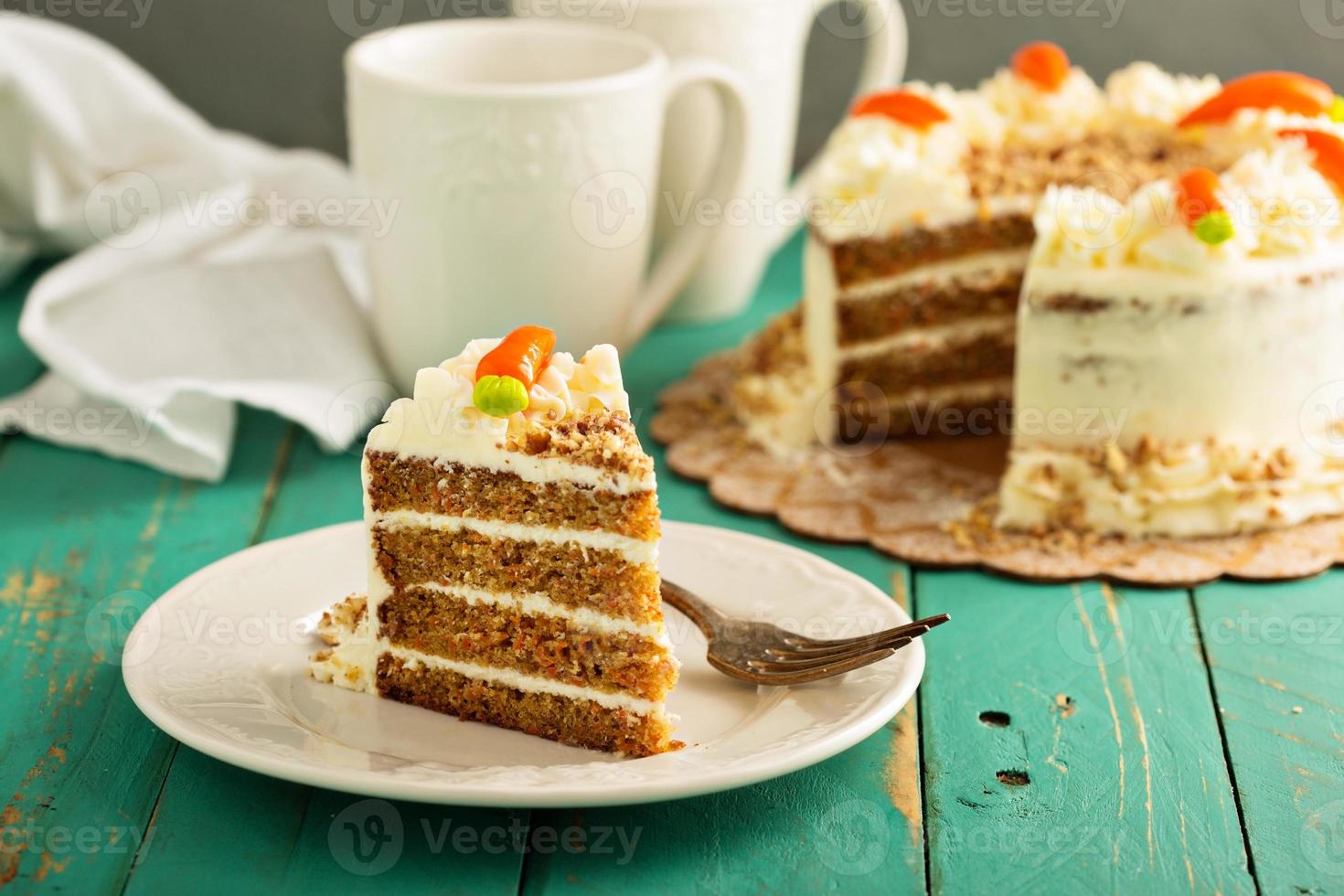 Slice of carrot cake with cream cheese frosting photo