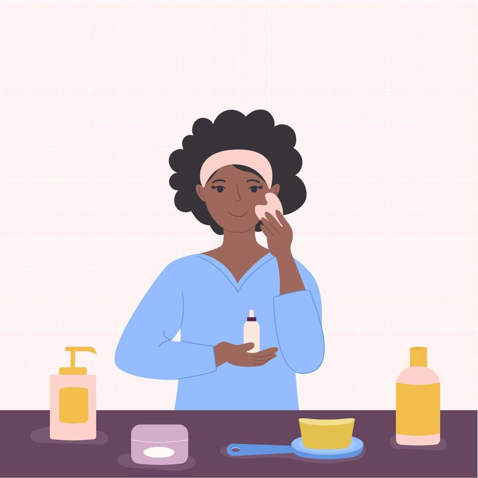 A black African American woman in a bathroom applies a serum and massages with a scrubber. vector