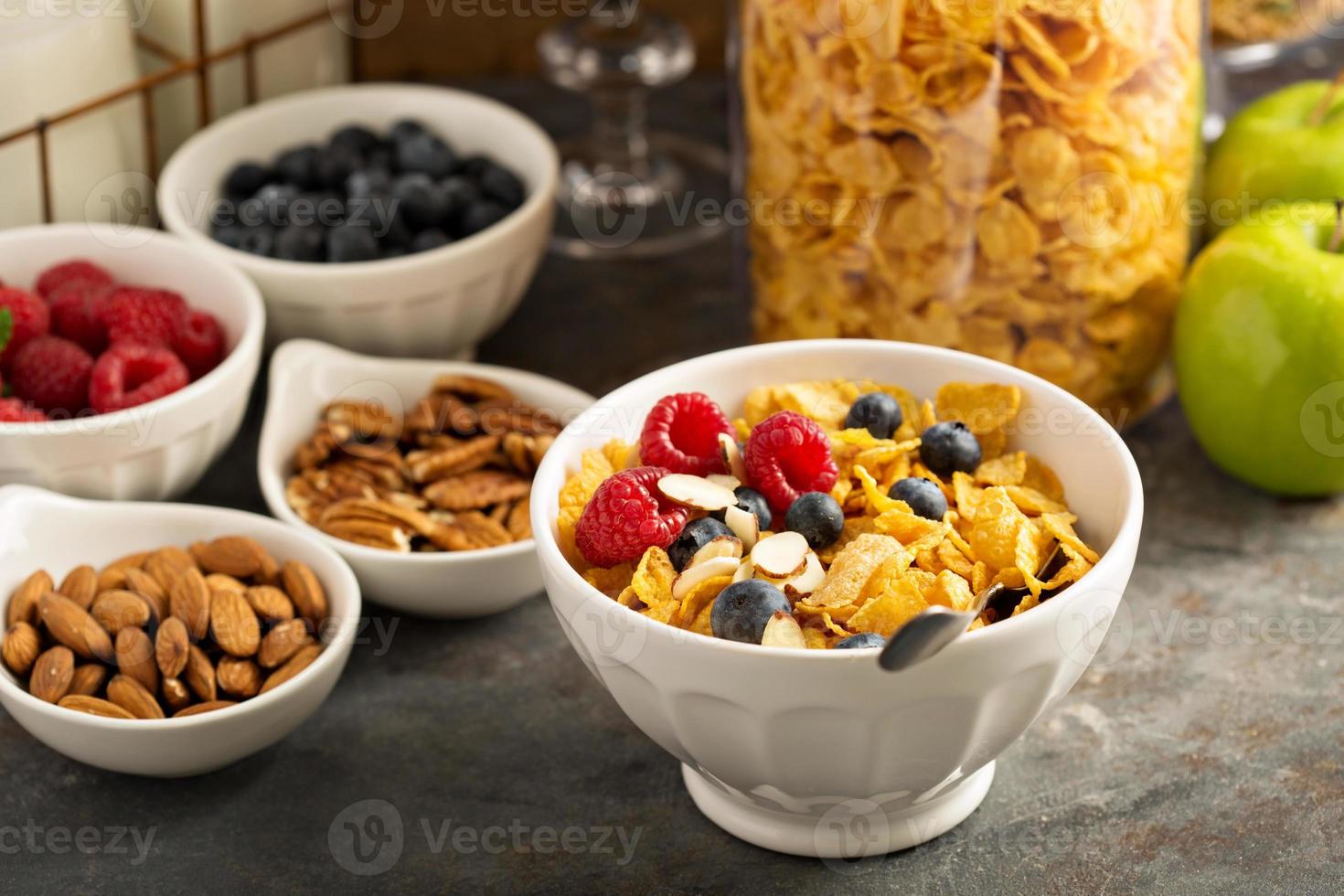 Cereal bar or buffet wih cornflakes, fruit and nuts photo