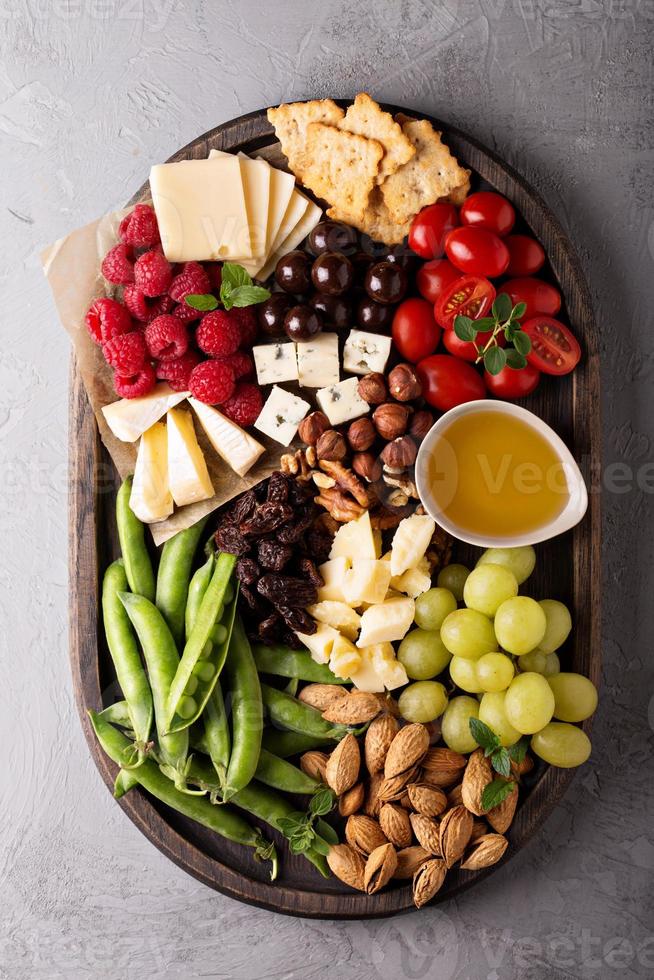 Cheese plate with fresh vegetables and fruits photo