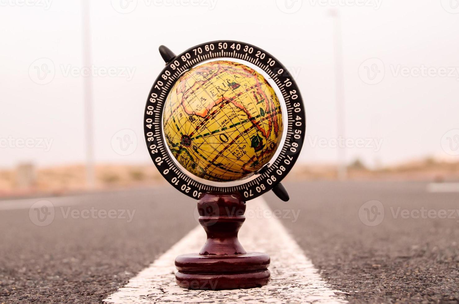Globe miniature on the ground photo