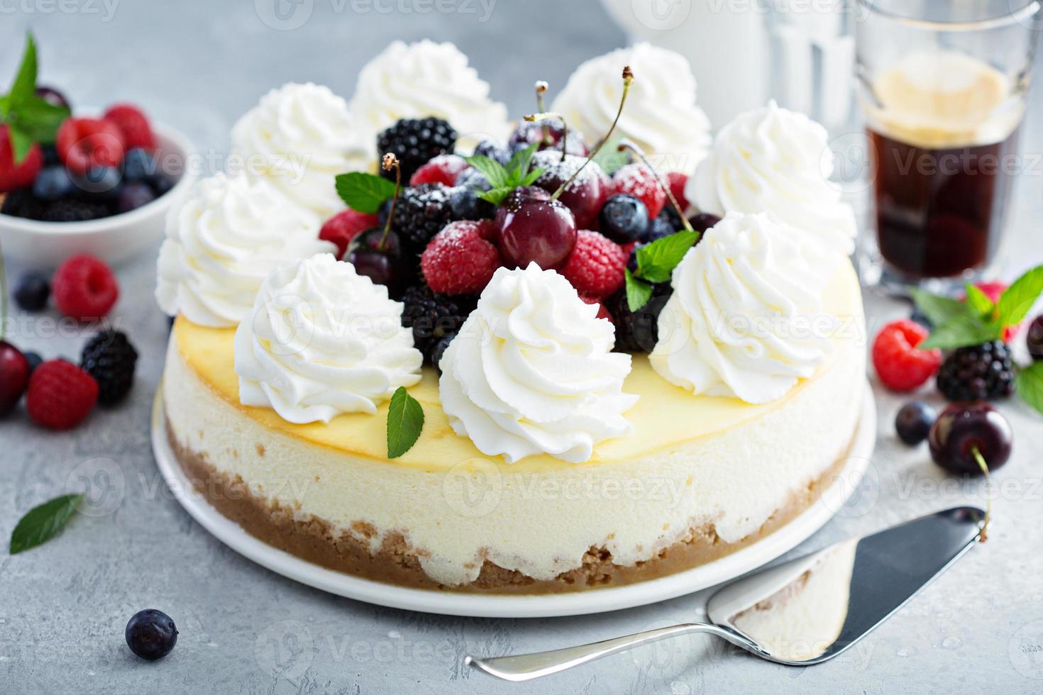 Classic New York cheesecake decorated with whipped cream photo