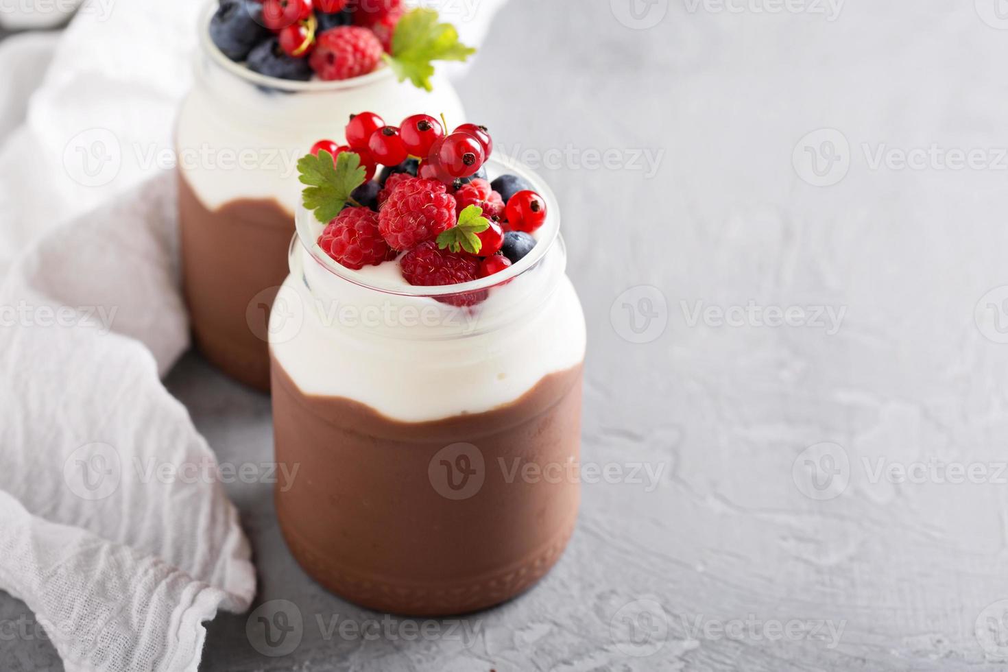 Chocolate pudding with cream and fresh berries photo