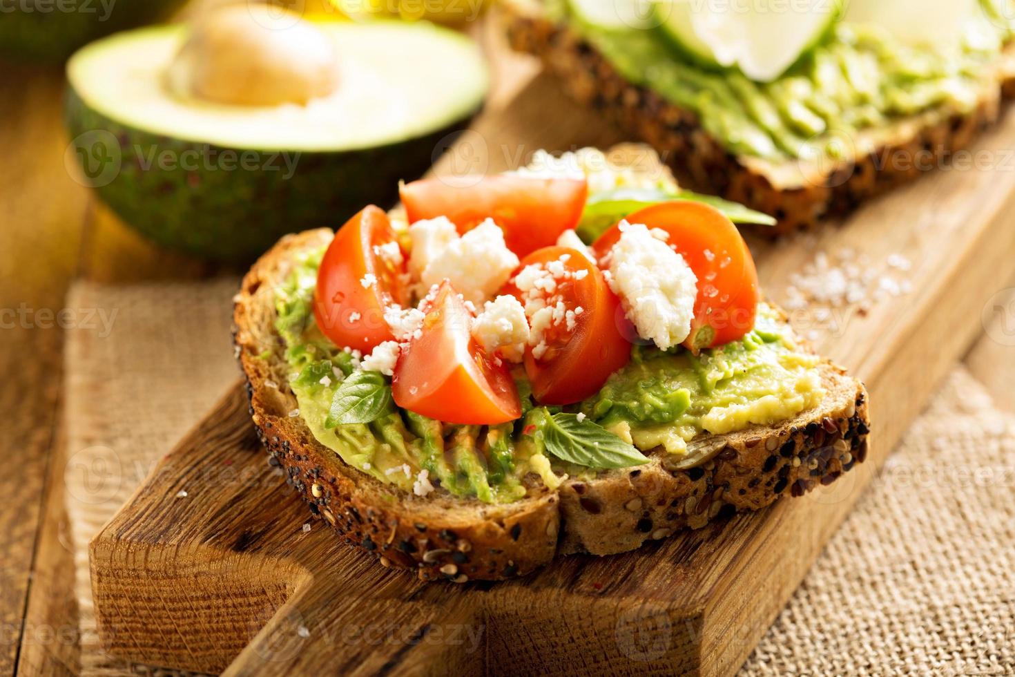 Avocado toast with tomatoes and feta photo