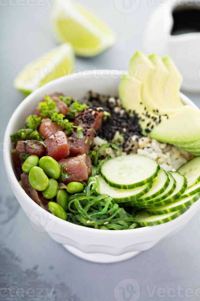 Poke bowl with raw tuna, rice and vegetables photo