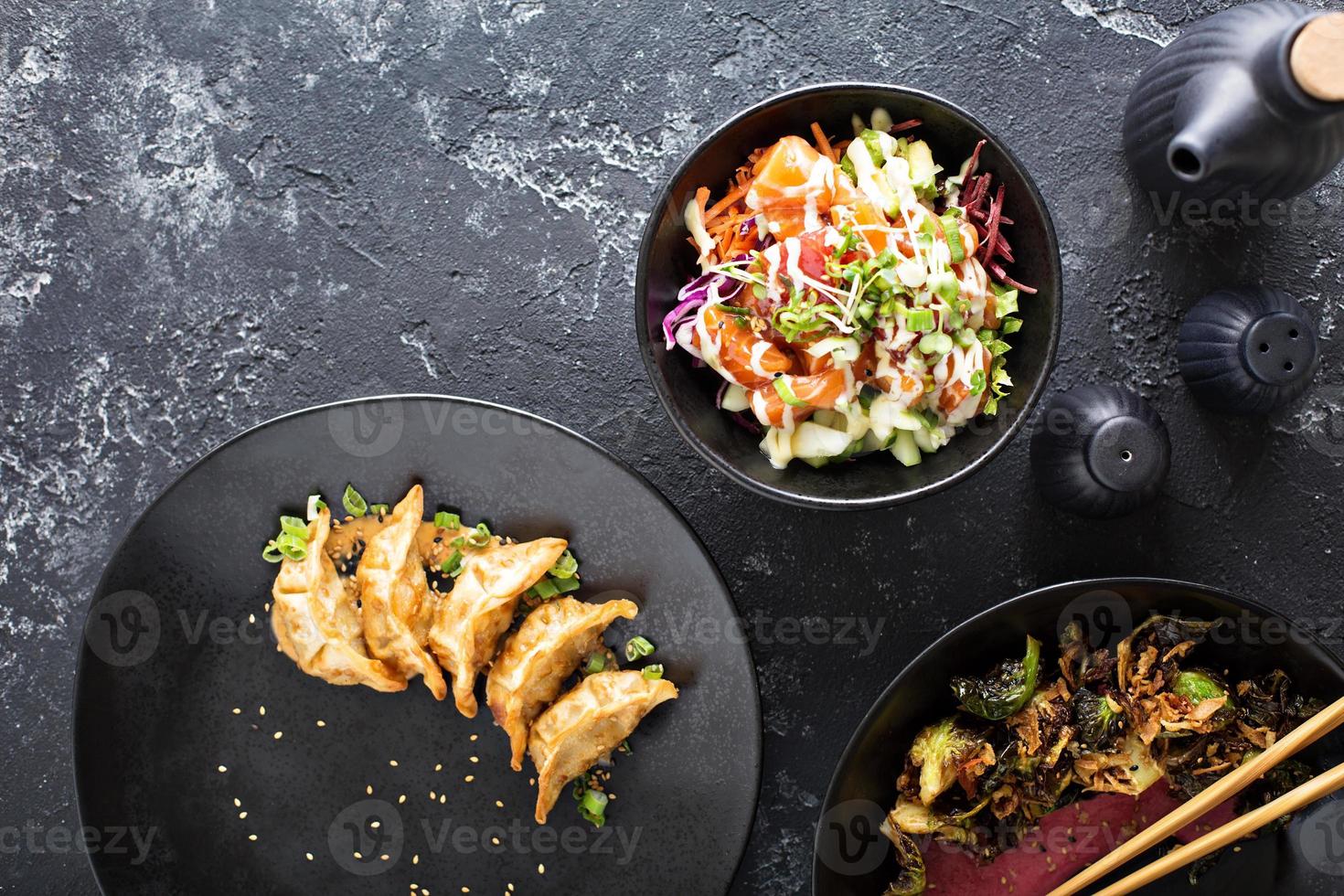 Asian cuisine dishes on the table overhead view photo