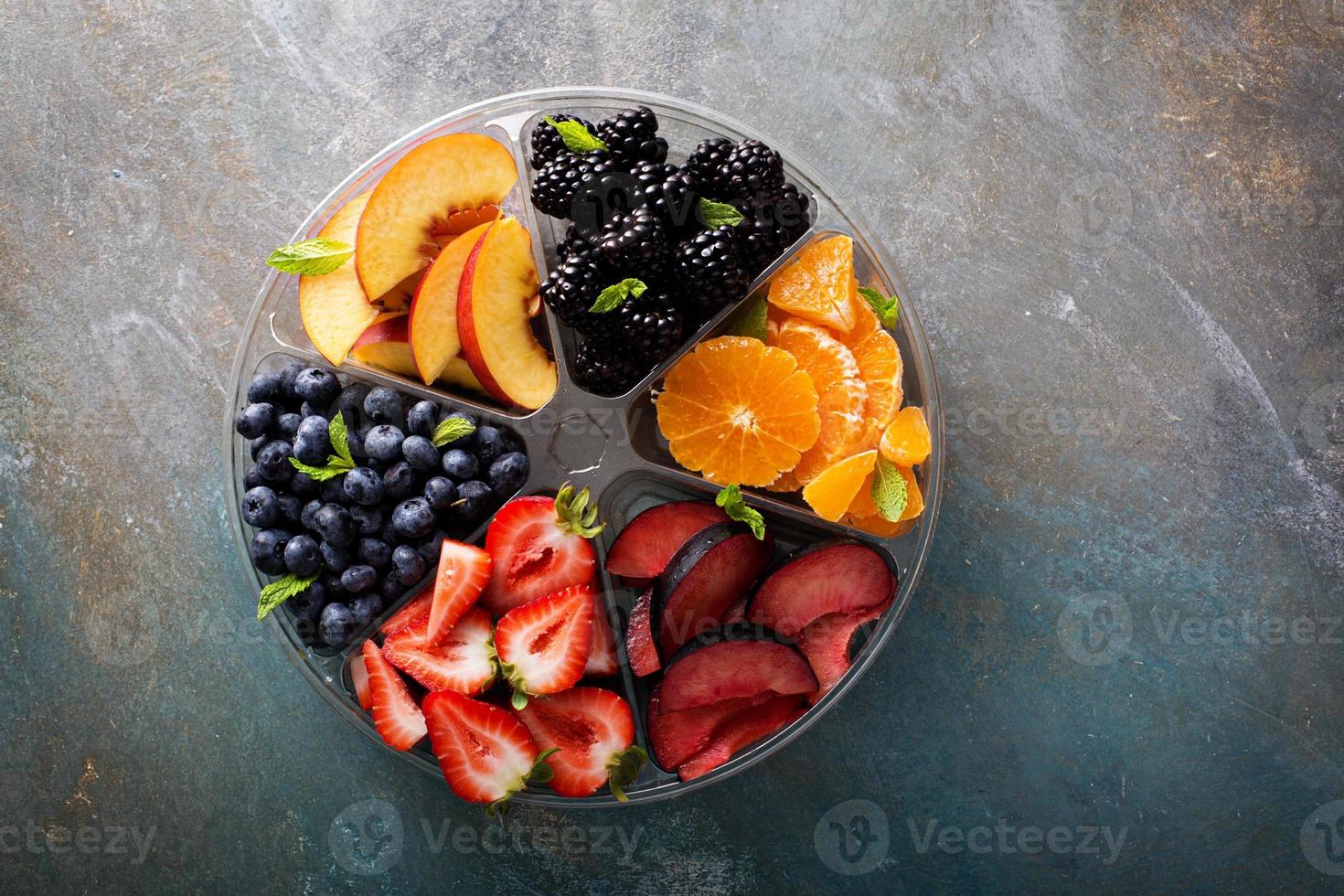 Assorted fruit and berries on a plate photo