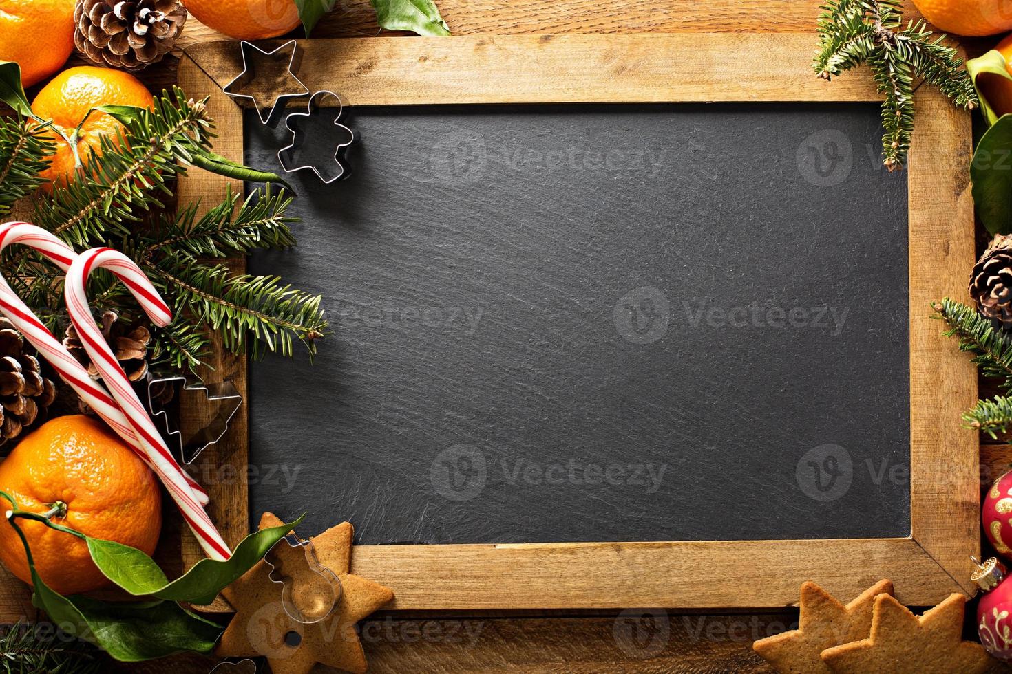 Christmas background with chalkboard, pine branches and oranges photo