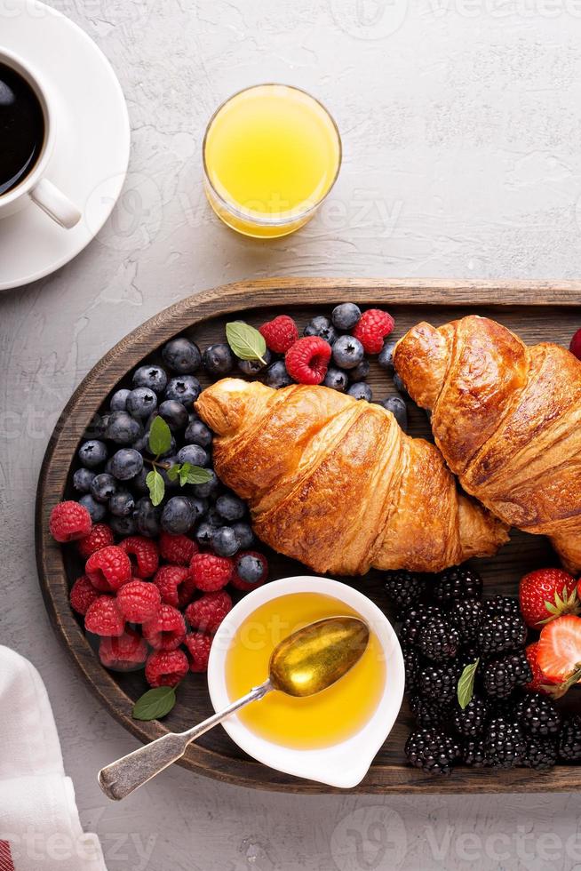 Croissants with fresh berry and honey photo