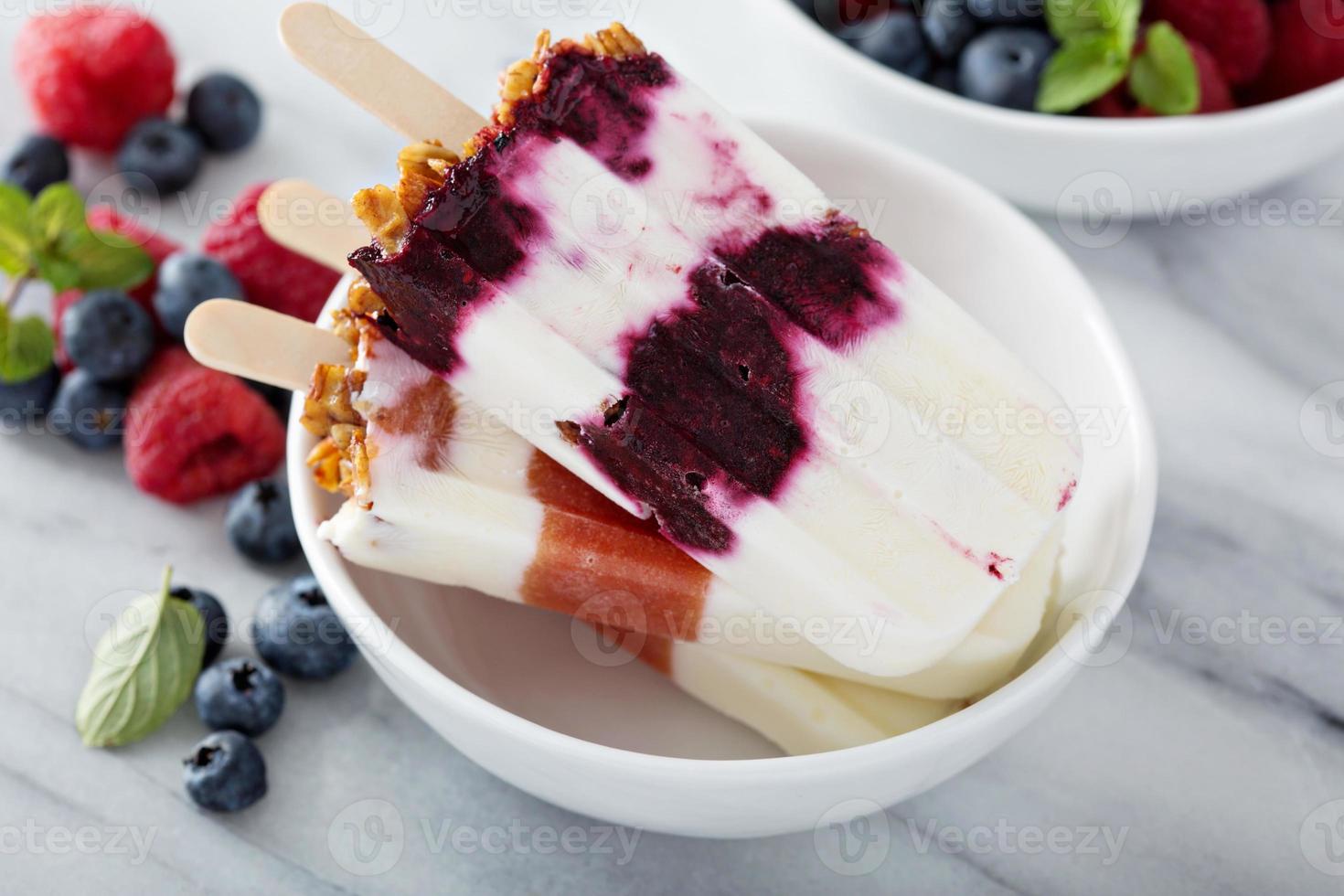 Yogurt, fruit and granola breakfast popsicles photo