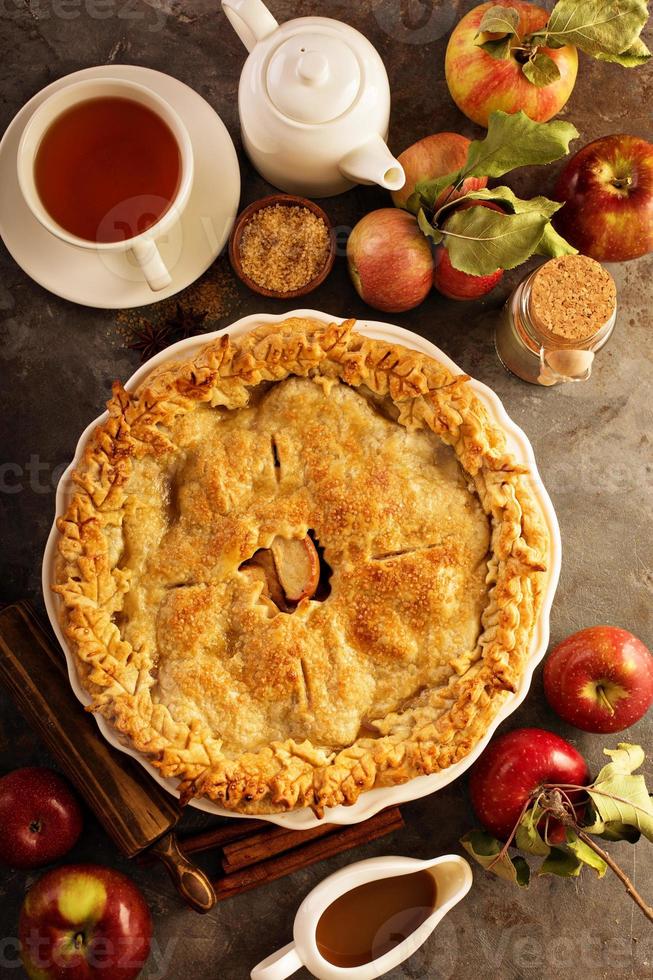 Apple pie decorated with fall leaves photo