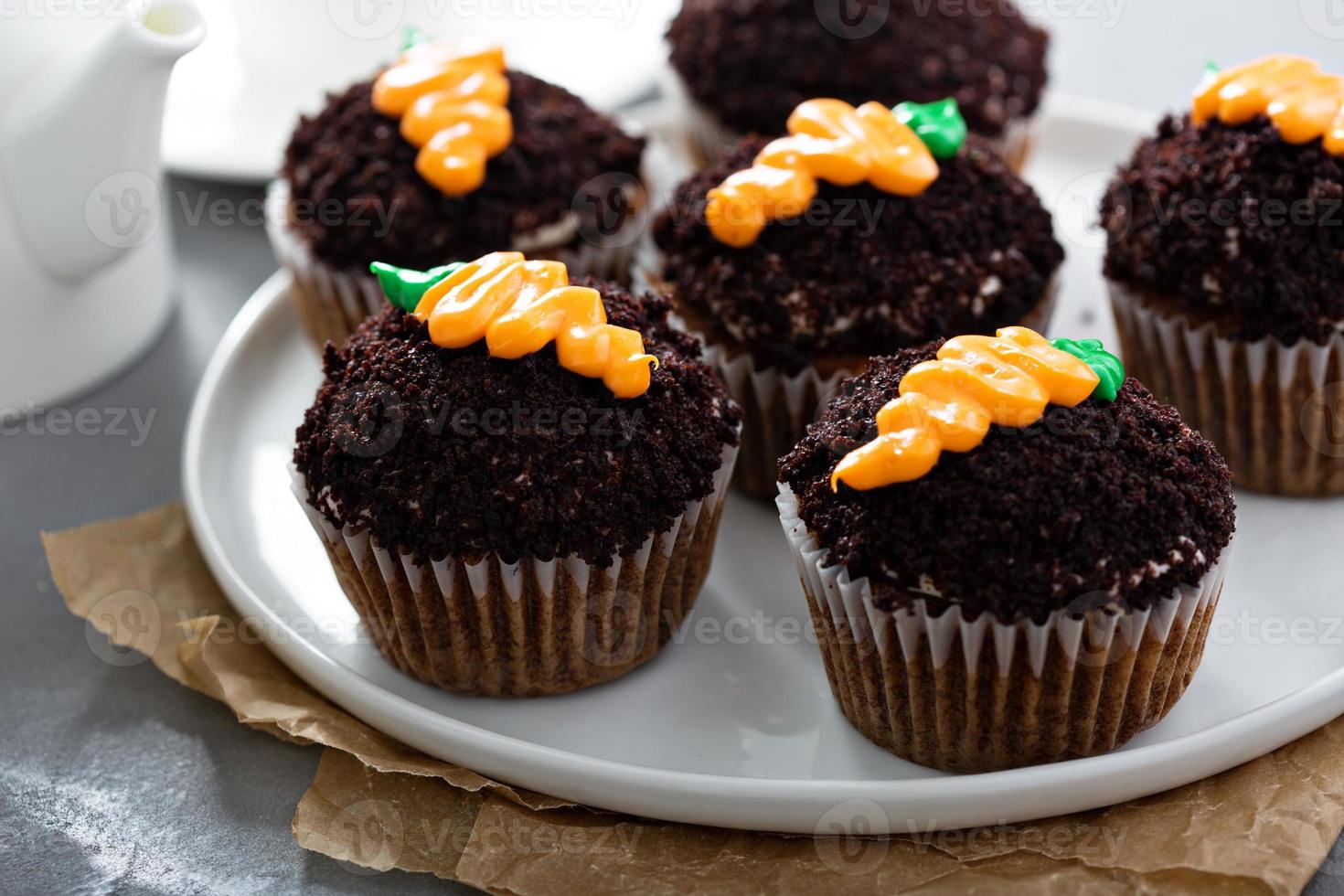 Carrot cupcakes with chocolate crumbs and frosting photo