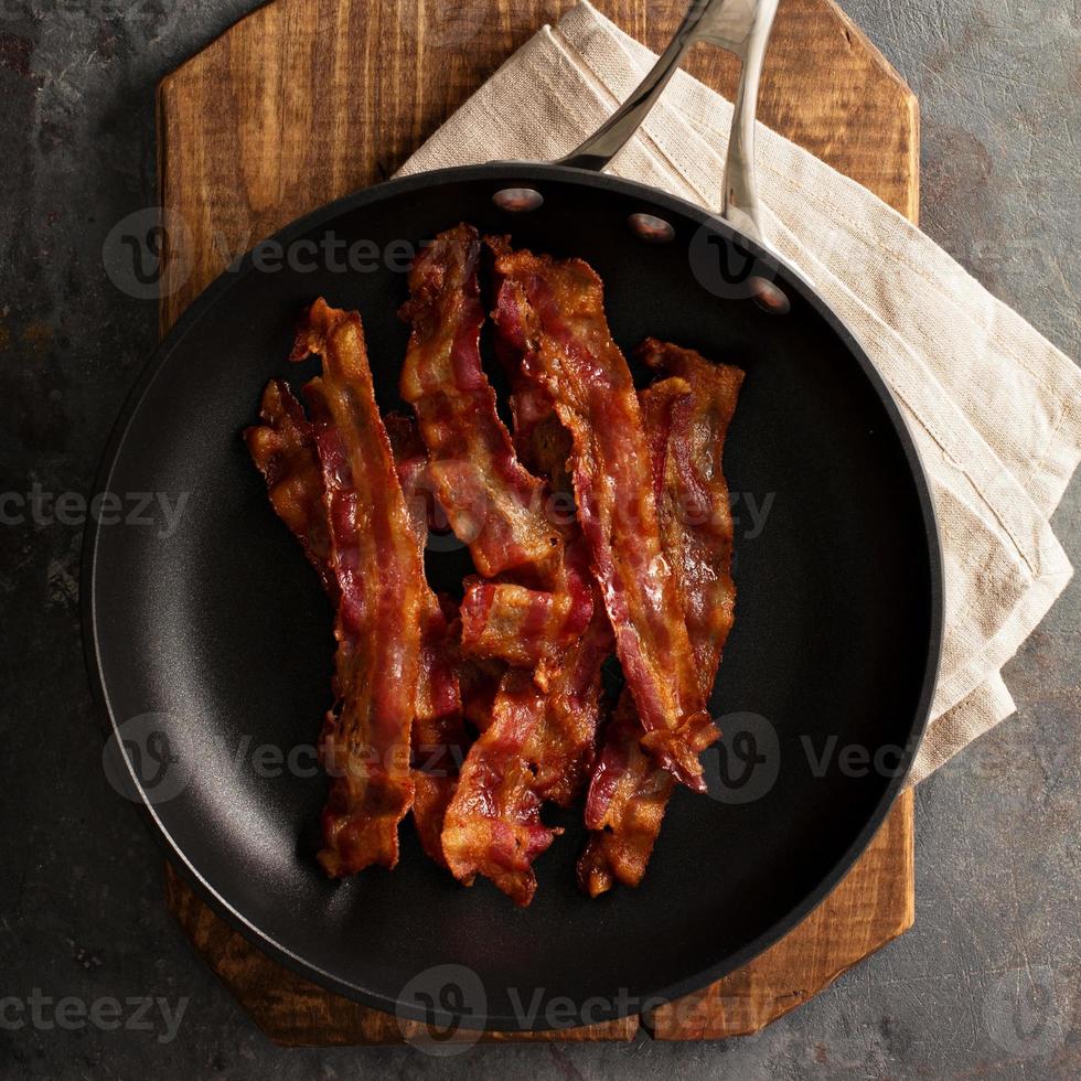 Cooked bacon on a skillet photo