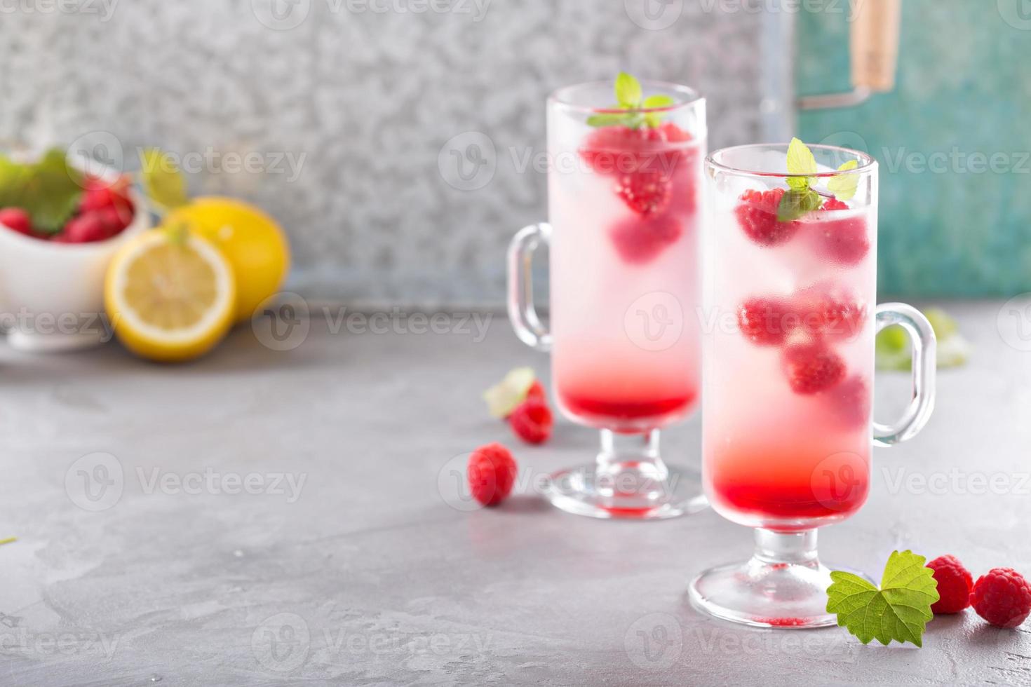 Pink raspberry lemonade in tall glasses photo