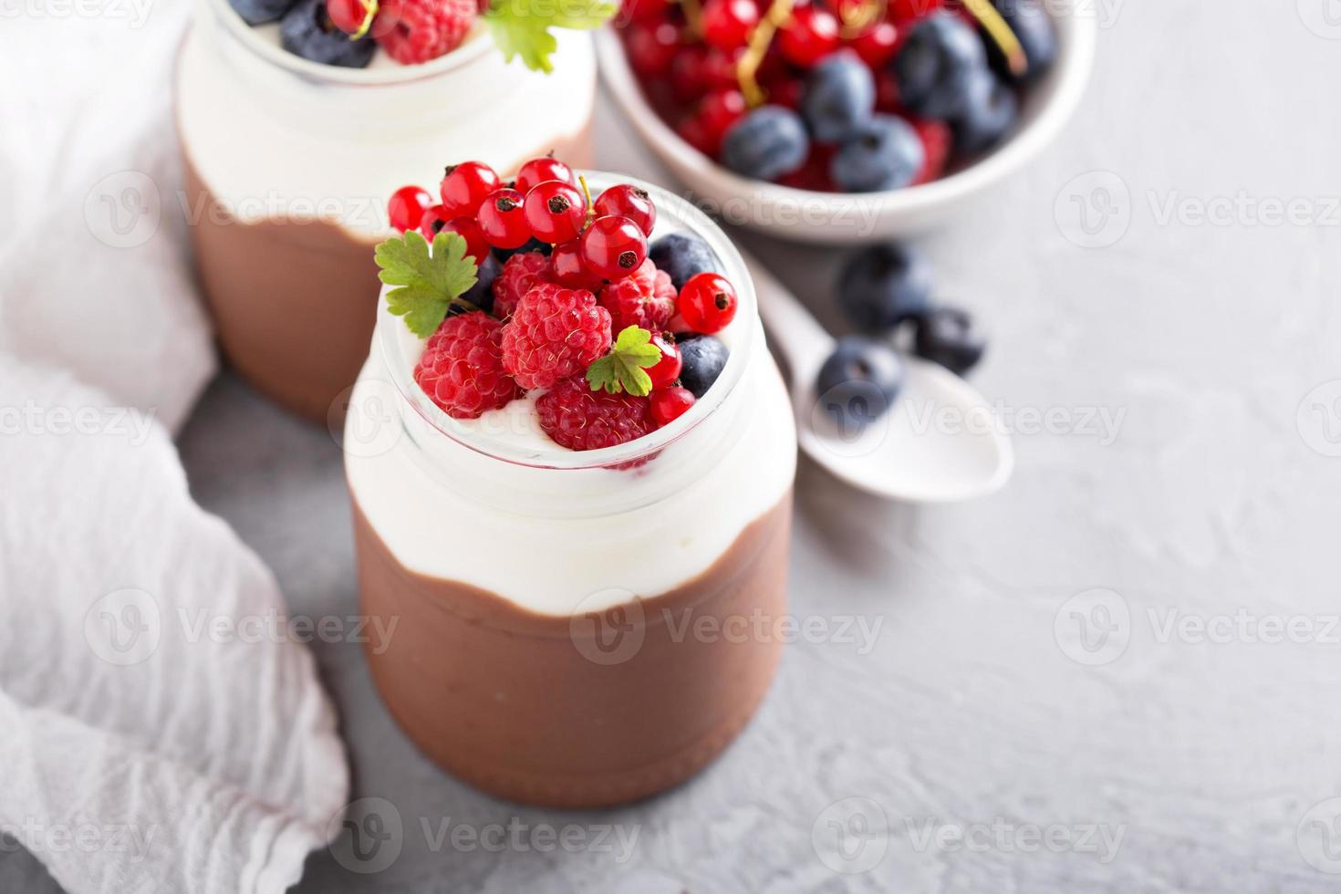 Chocolate pudding with cream and fresh berries photo