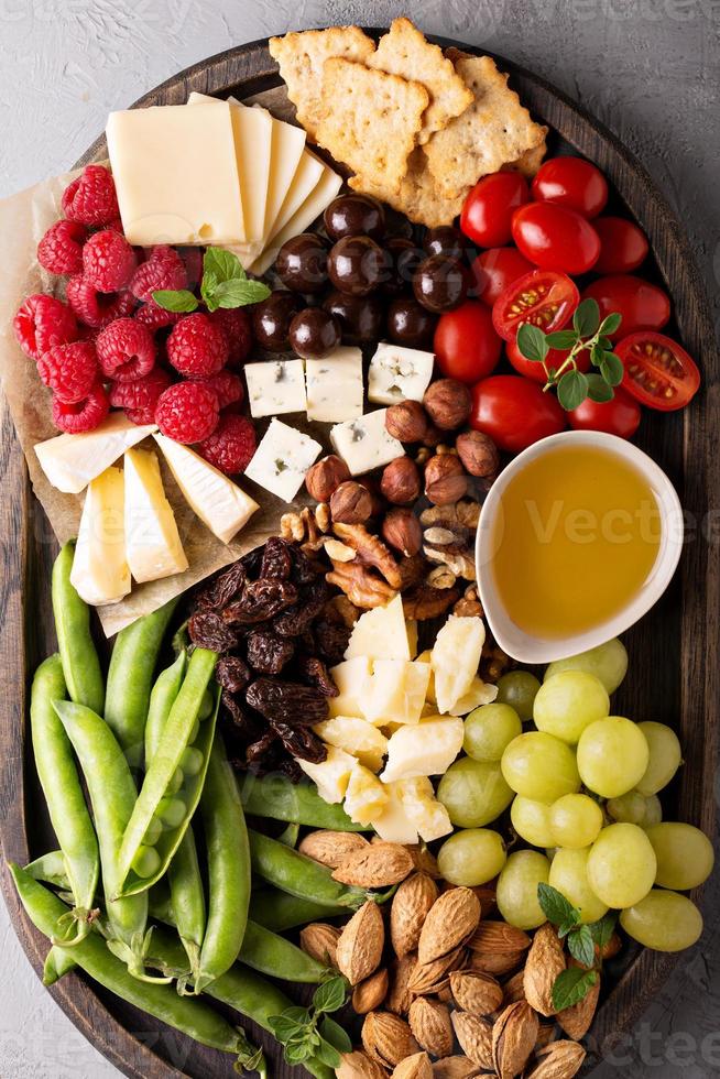 plato de queso con verduras y frutas frescas foto