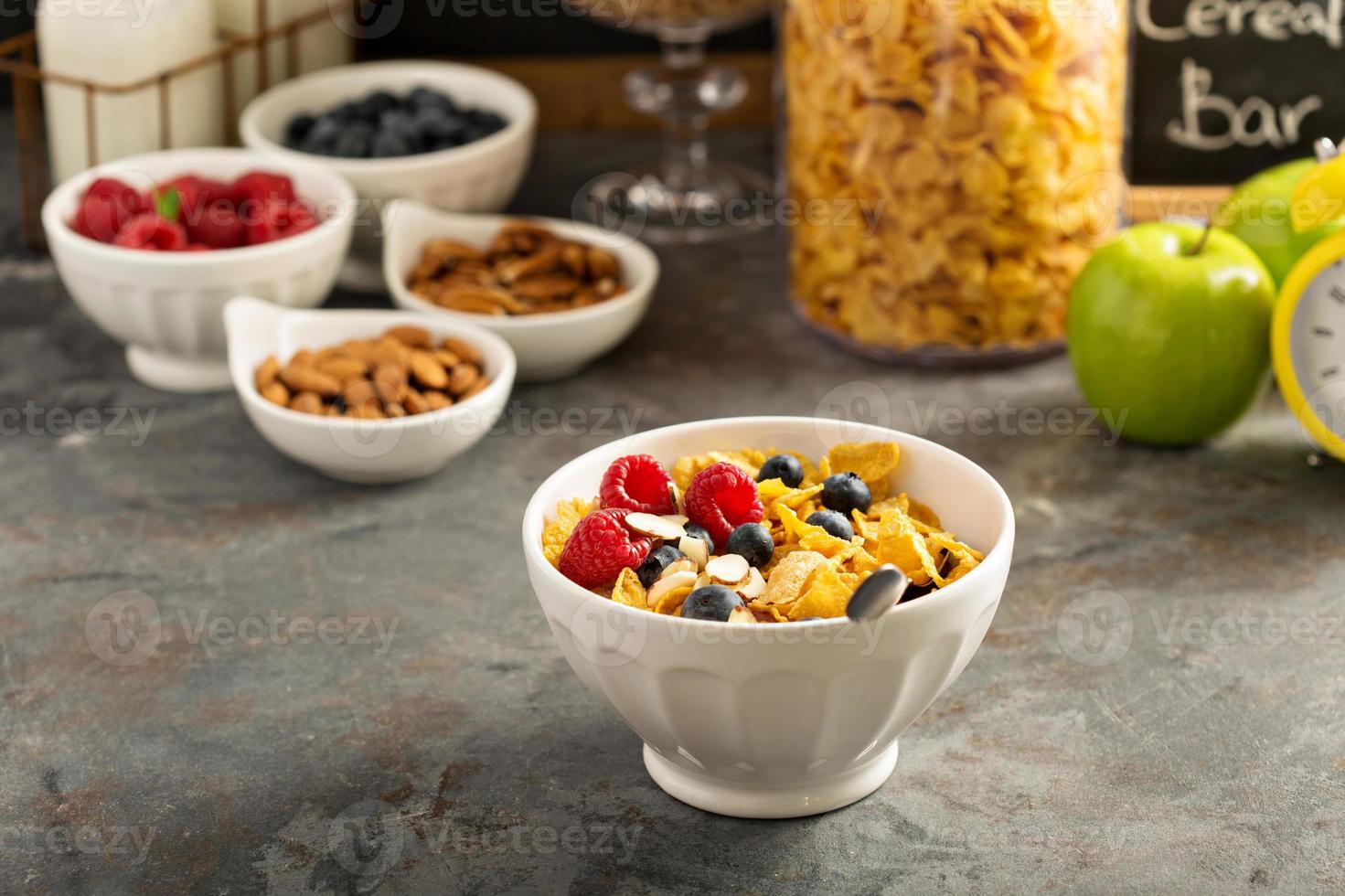 Cereal bar or buffet wih cornflakes, fruit and nuts photo