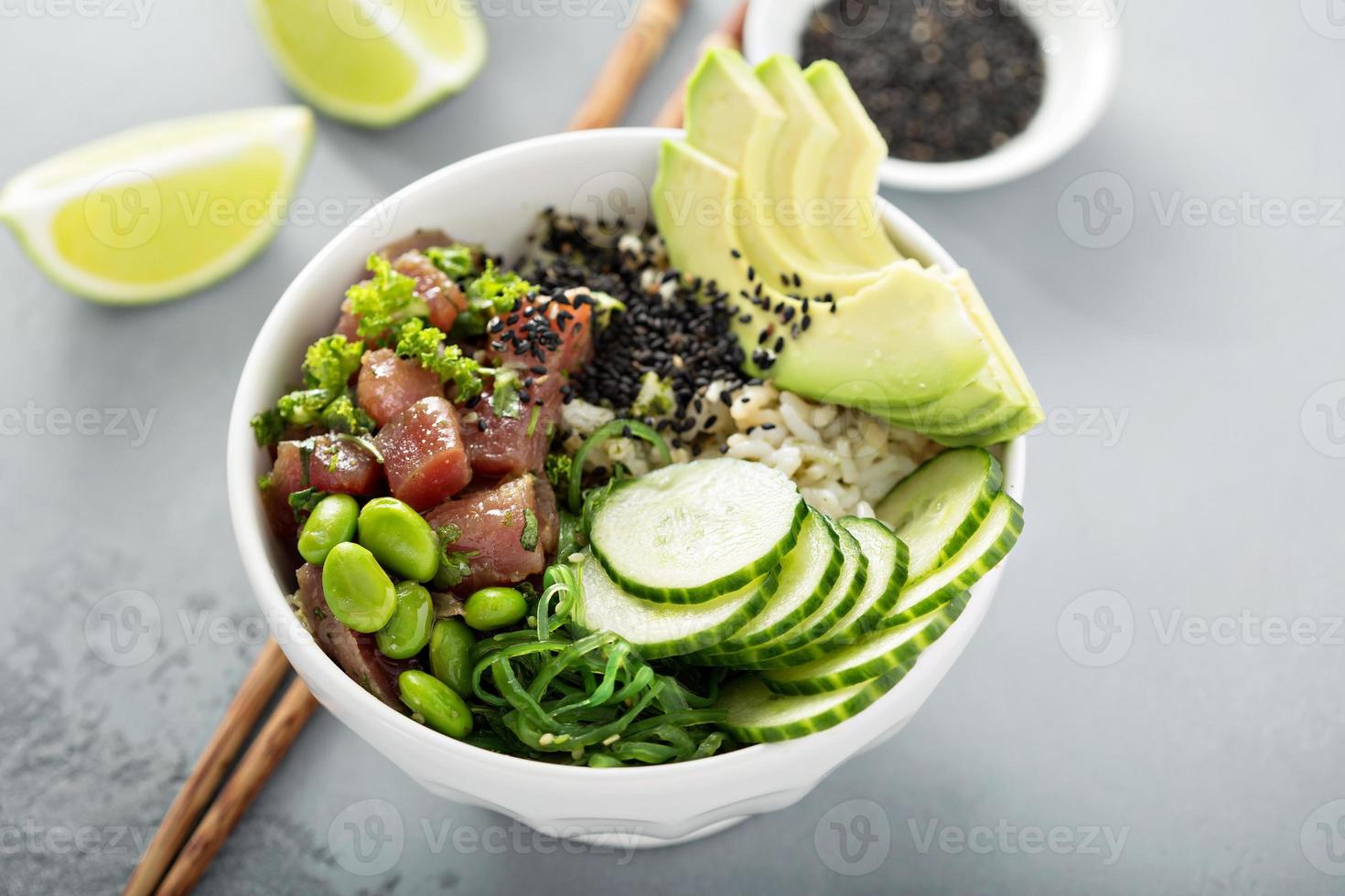 Poke bowl with raw tuna, rice and vegetables photo