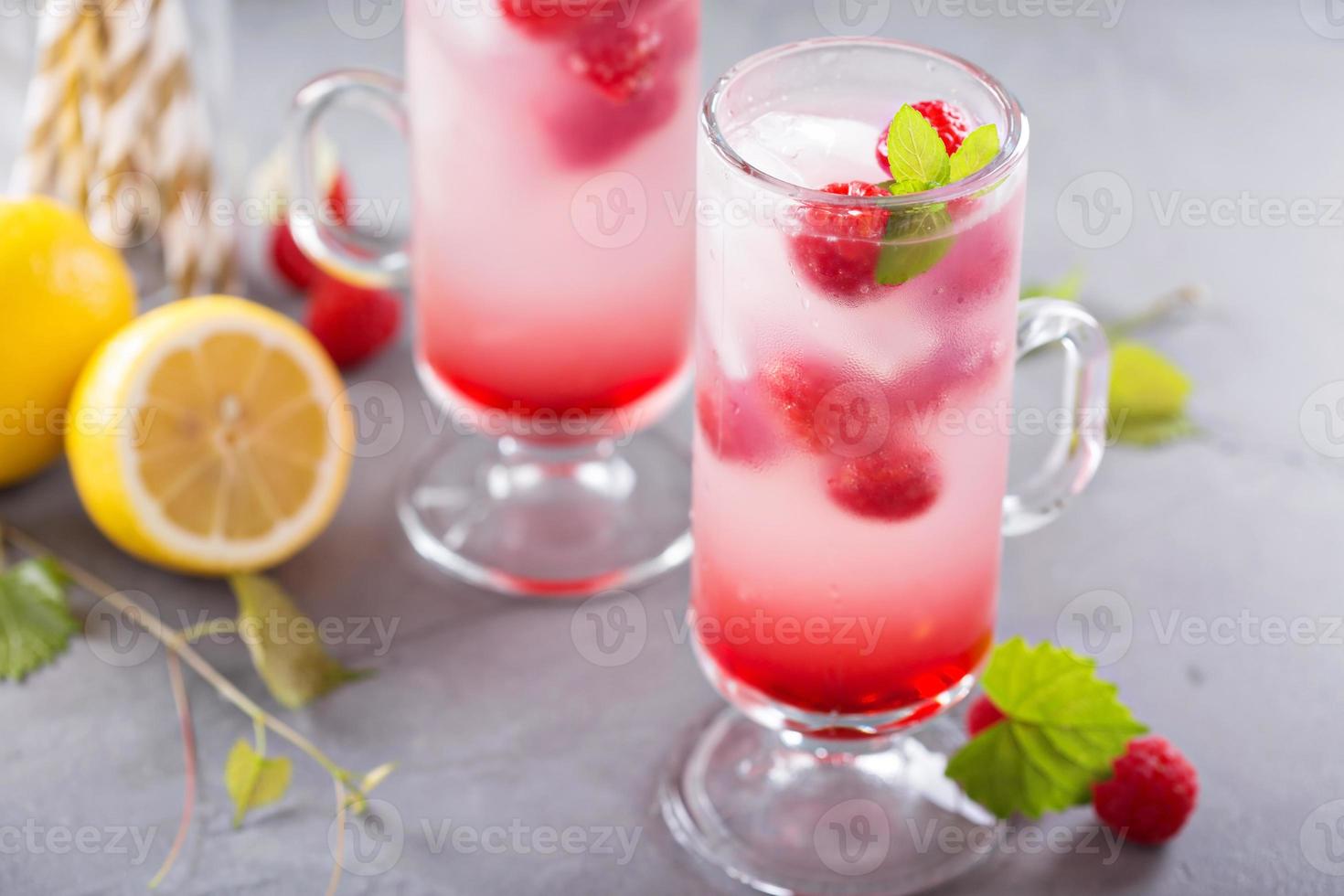 Pink raspberry lemonade in tall glasses photo