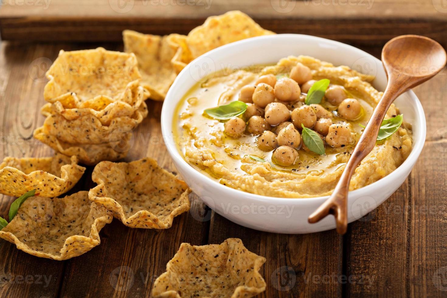 hummus casero con tazones de tortilla foto