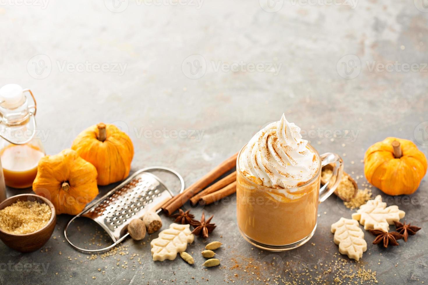 Pumpkin spice latte in a glass mug photo
