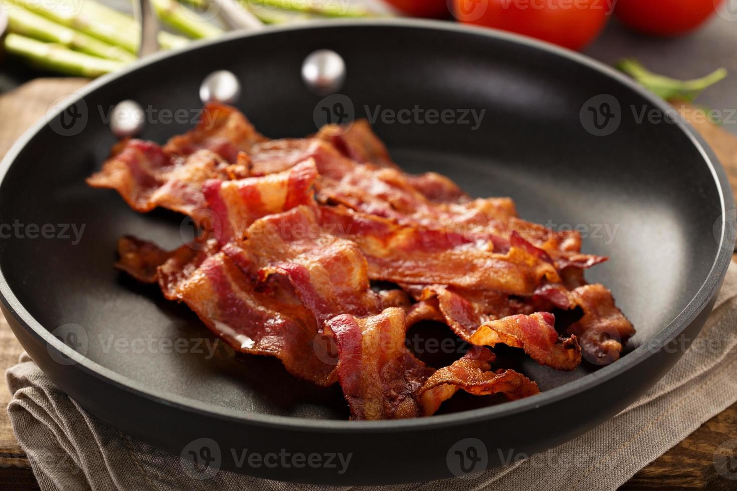 Cooked bacon on a skillet photo