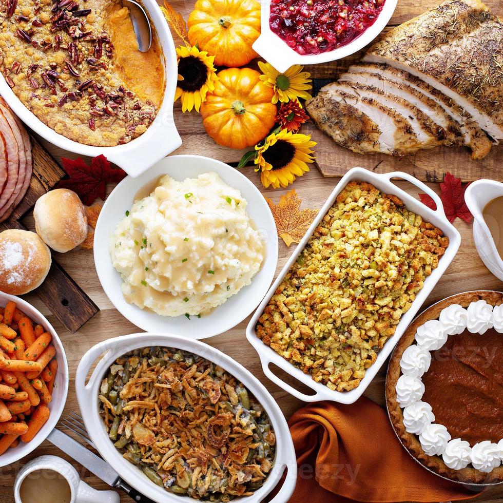 Thanksgiving table with turkey and sides photo