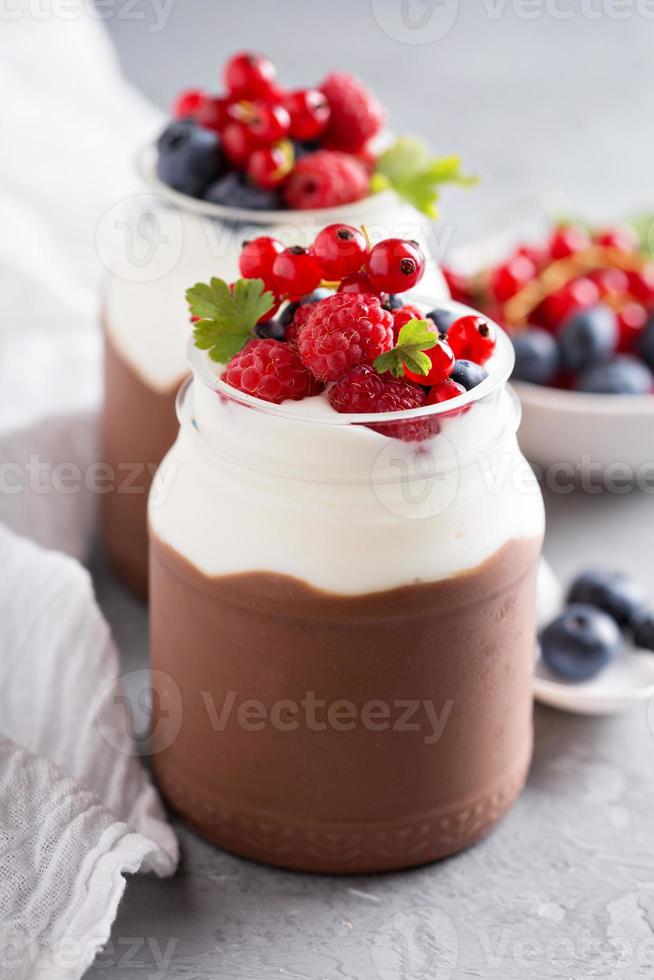 Chocolate pudding with cream and fresh berries photo