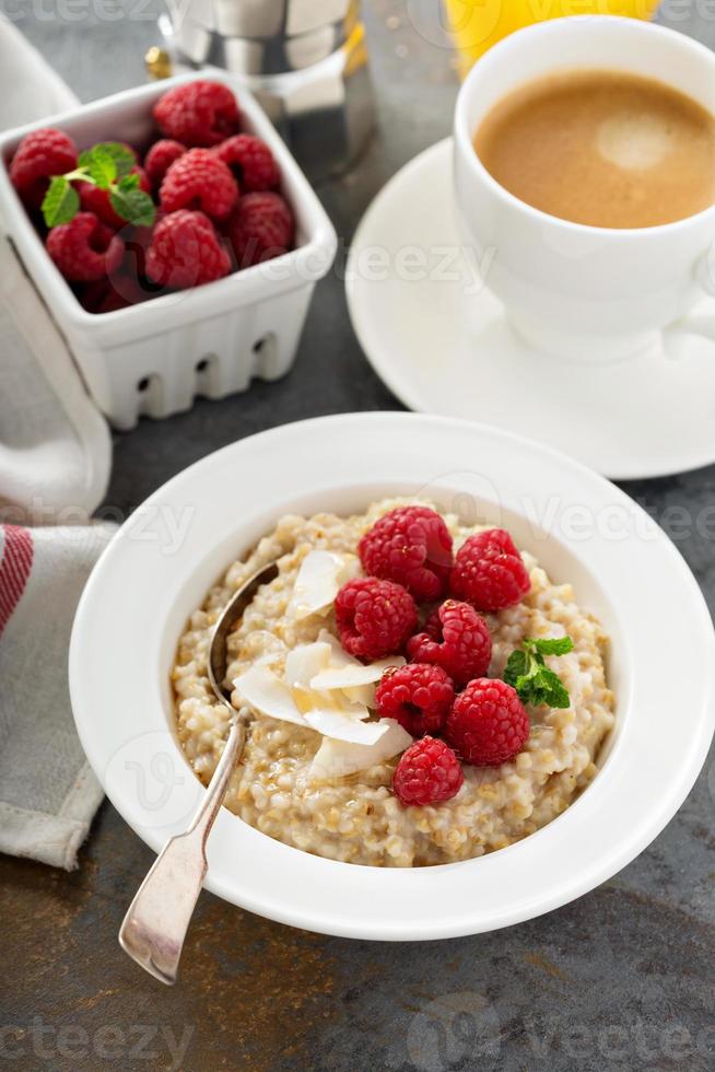Steel cut oatmeal porridge with raspberry and coconut photo