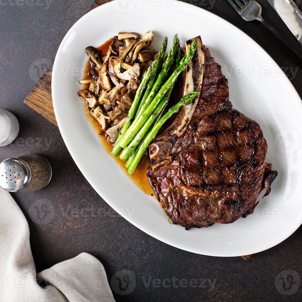 Beef steak with asparagus and mushrooms photo