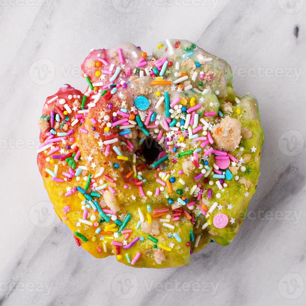 Unicorn donut on marble surface photo