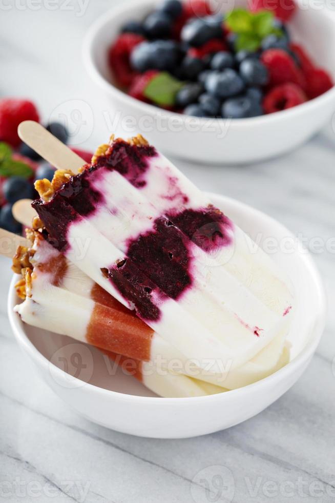 Yogurt, fruit and granola breakfast popsicles photo