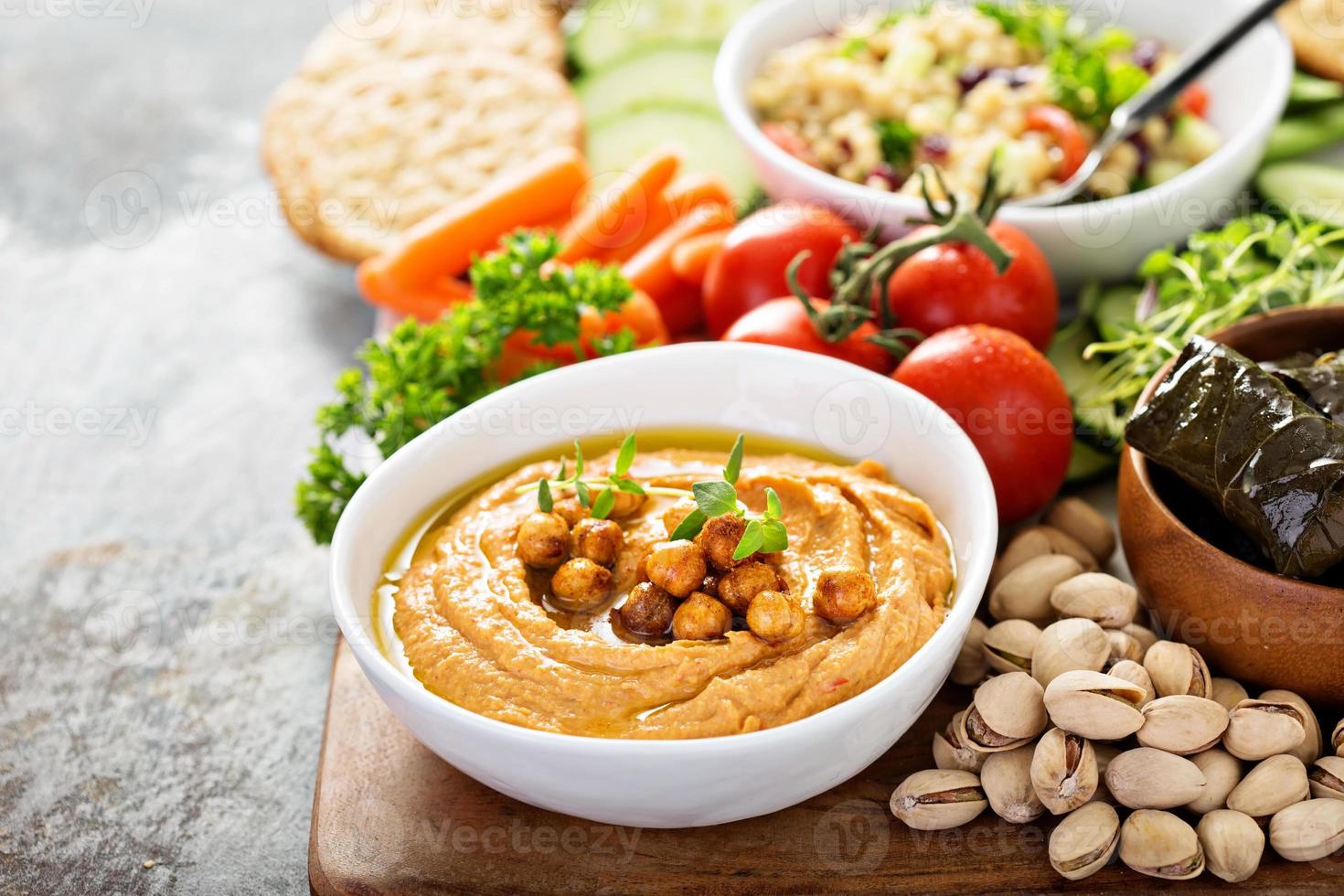 Hummus and vegetables platter with grain salad photo