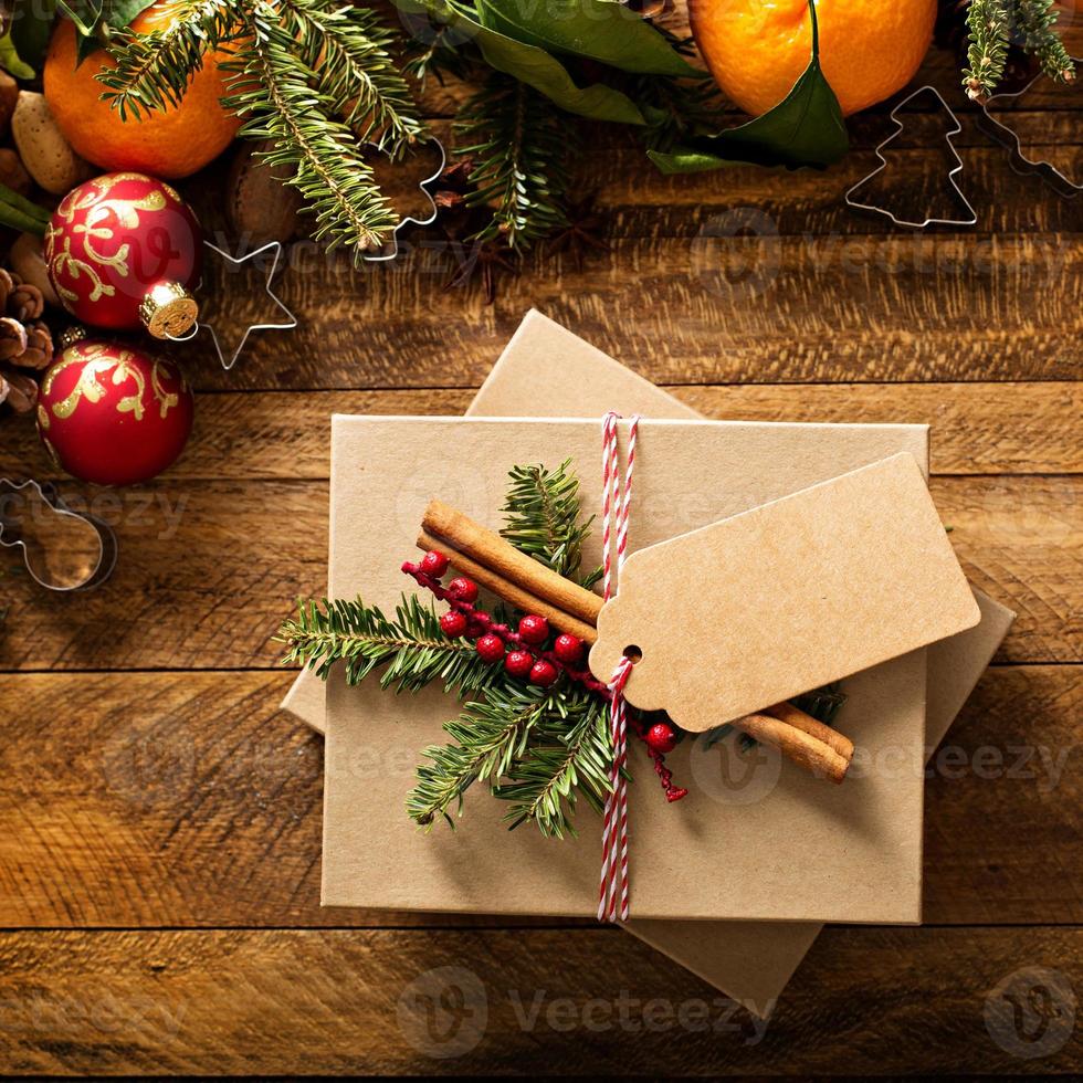 Christmas present with oranges, candy canes and decorations photo