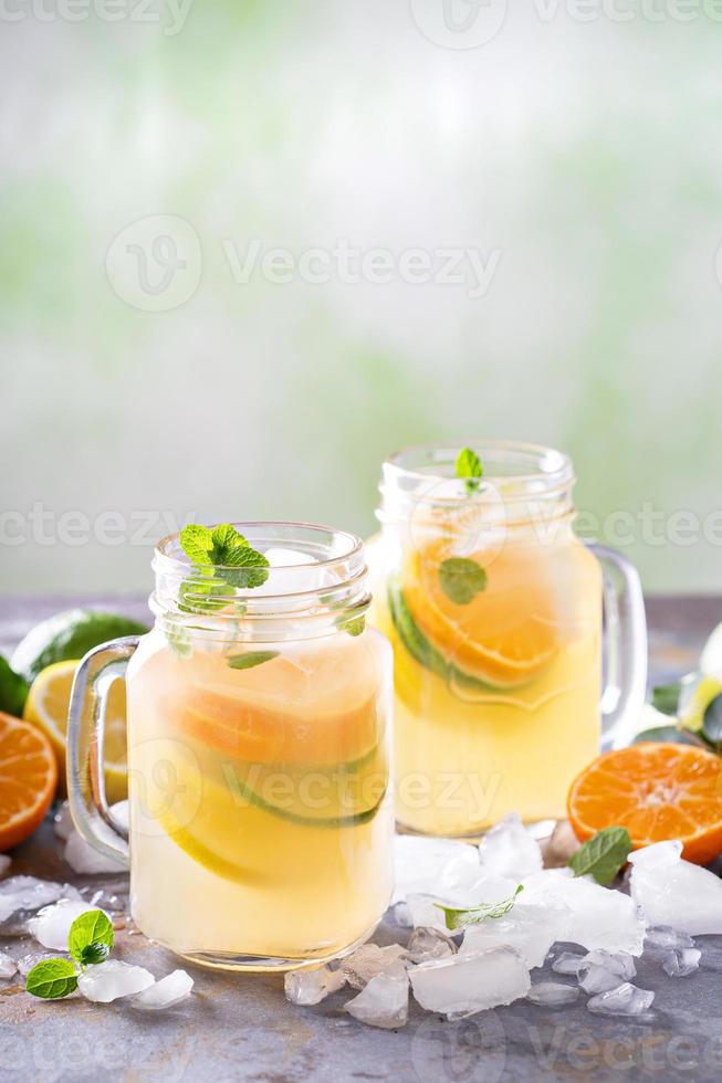 Citrus fruit lemonade in mason jars photo