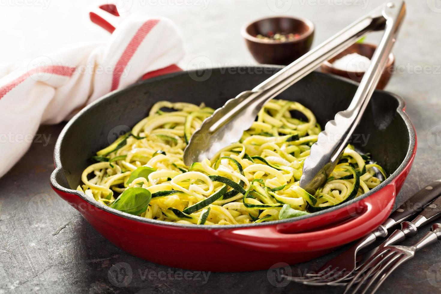 Spiralized zucchini noodles in a cast iron pan photo