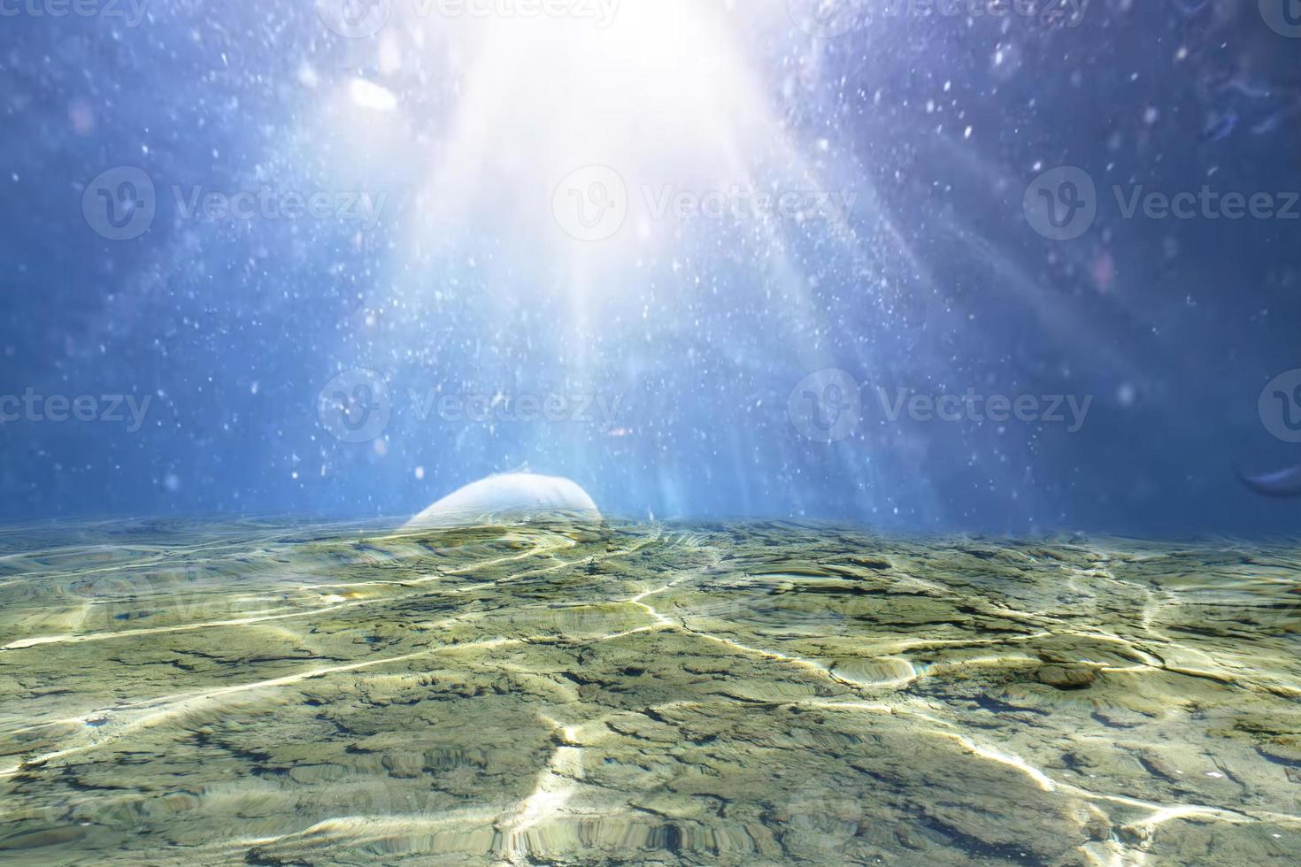Defocus blurred transparent blue under water surface texture with splashes and bubbles. Trendy abstract nature background. Ocean waves in sunlight with copy space. Blue under sea watercolor shining photo