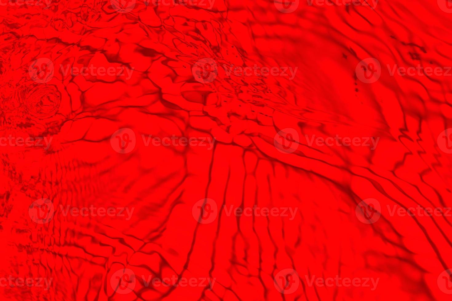 desenfoque borrosa transparente color rojo claro agua tranquila textura superficial con salpicaduras y burbujas. fondo de naturaleza abstracta de moda. ondas de agua a la luz del sol con espacio de copia. acuarela roja brillante foto