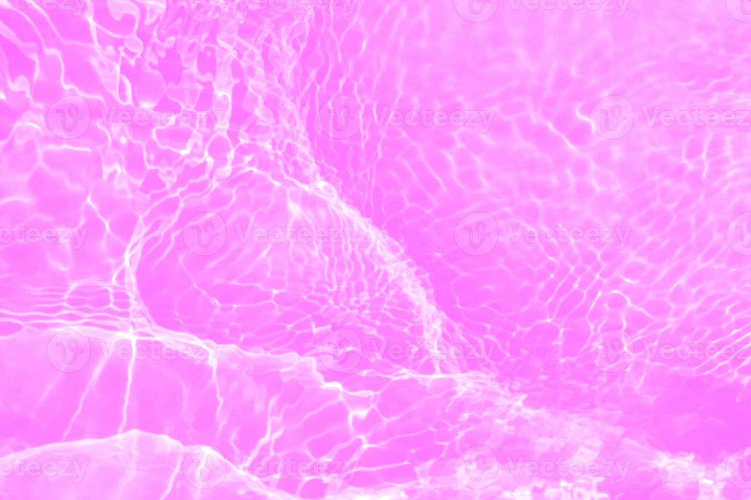 Defocus blurred transparent purple colored clear calm water surface texture with splashes and bubbles. Trendy abstract nature background. Water waves in sunlight with copy space. Pink water drop shine photo