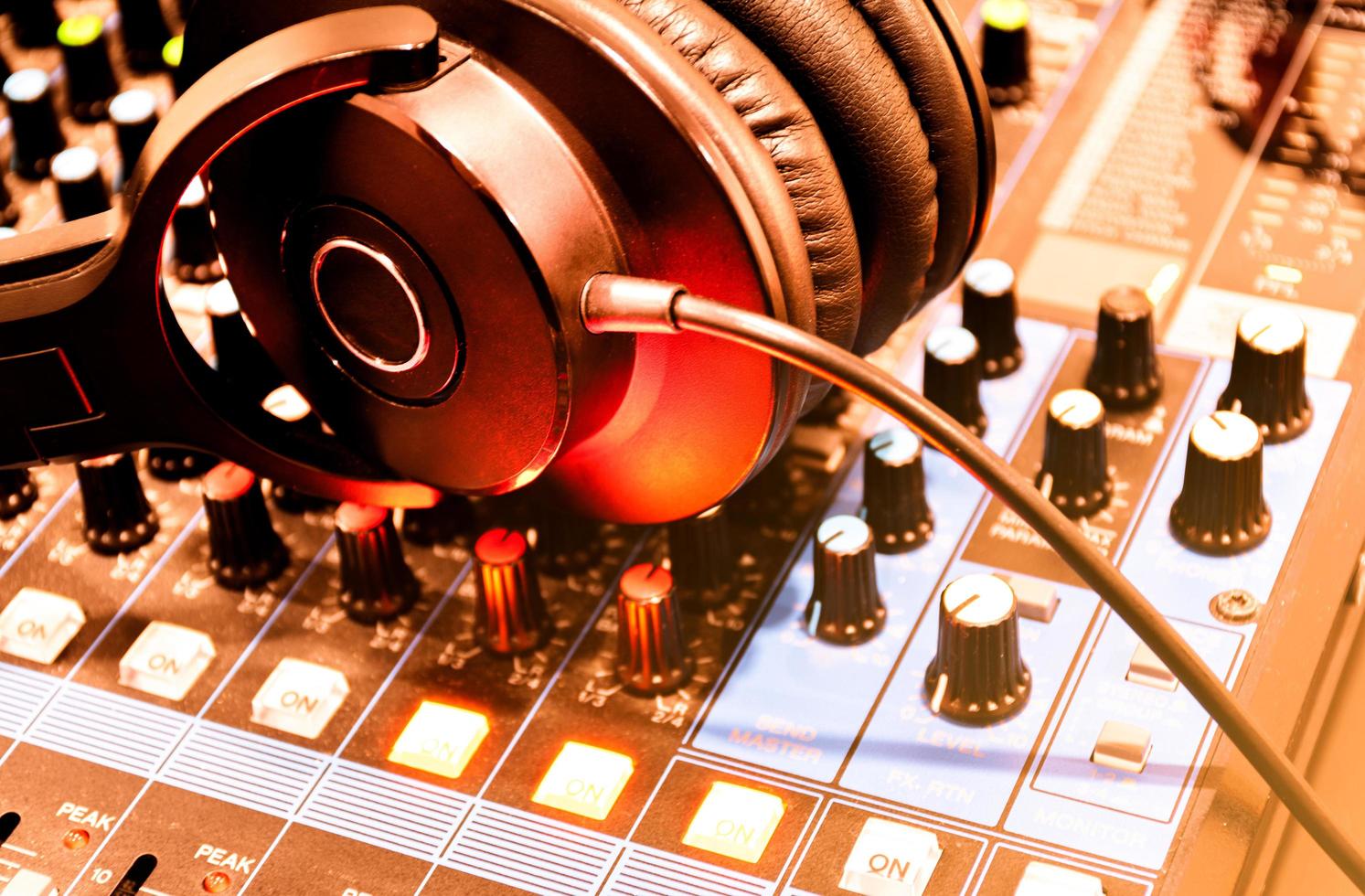 Top view black headphone on console sound board mixer photo