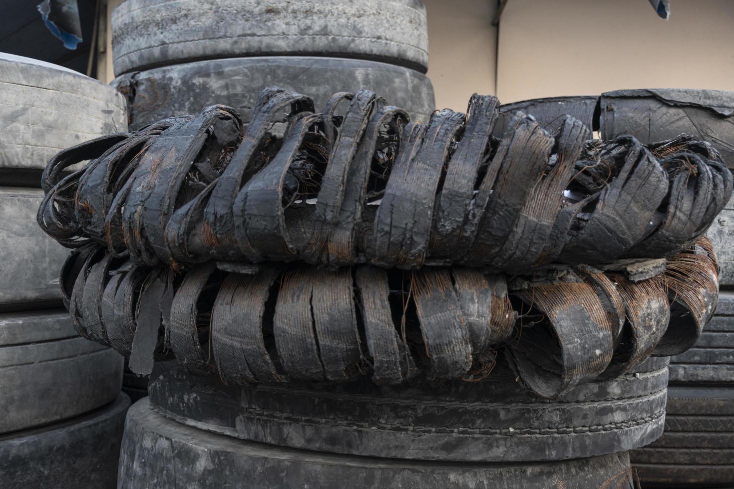 Old broken car tires stacked photo