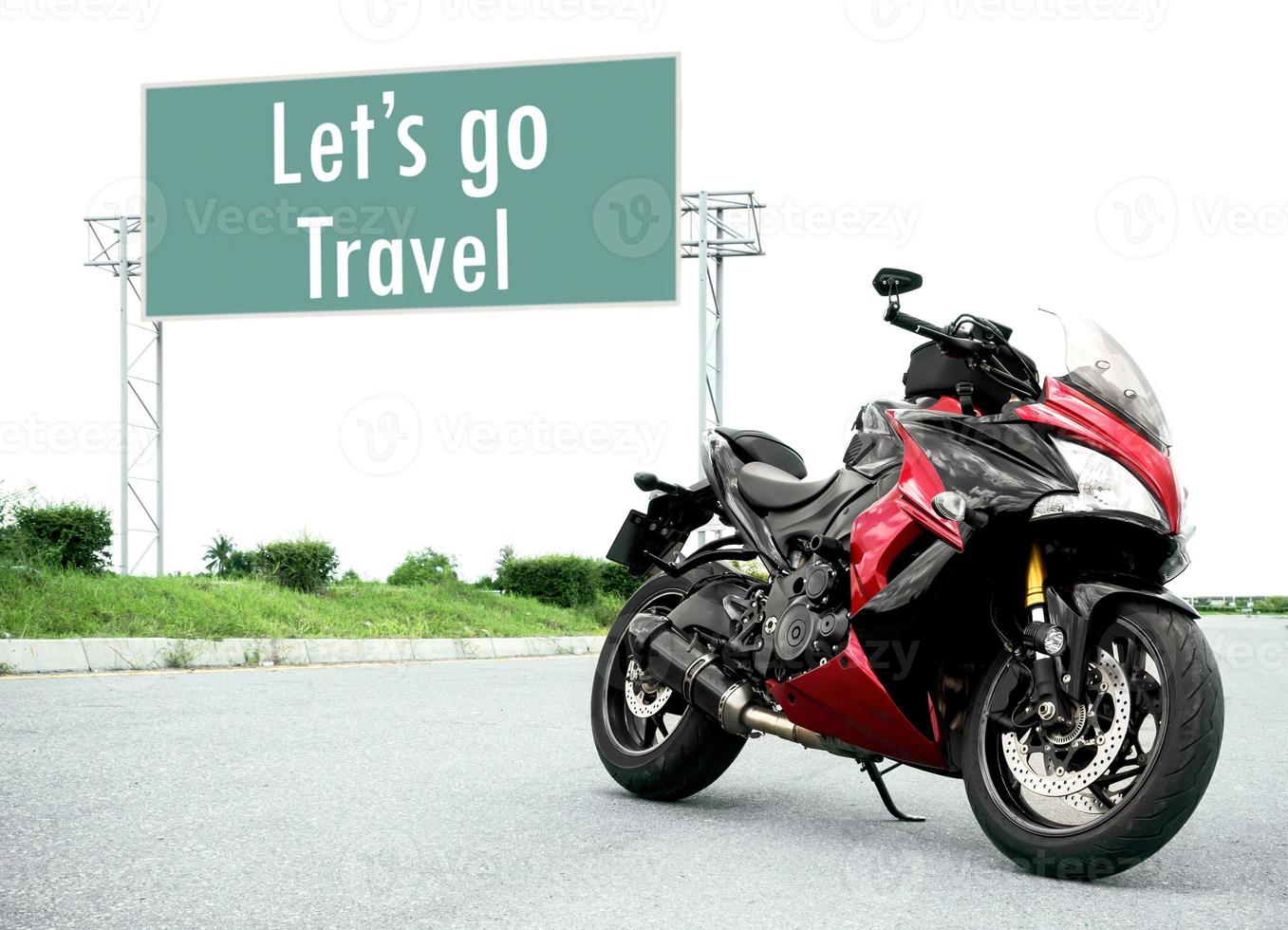 Red black motorcycle modern style parked on road with message Let's go Travel on green roadsign background photo