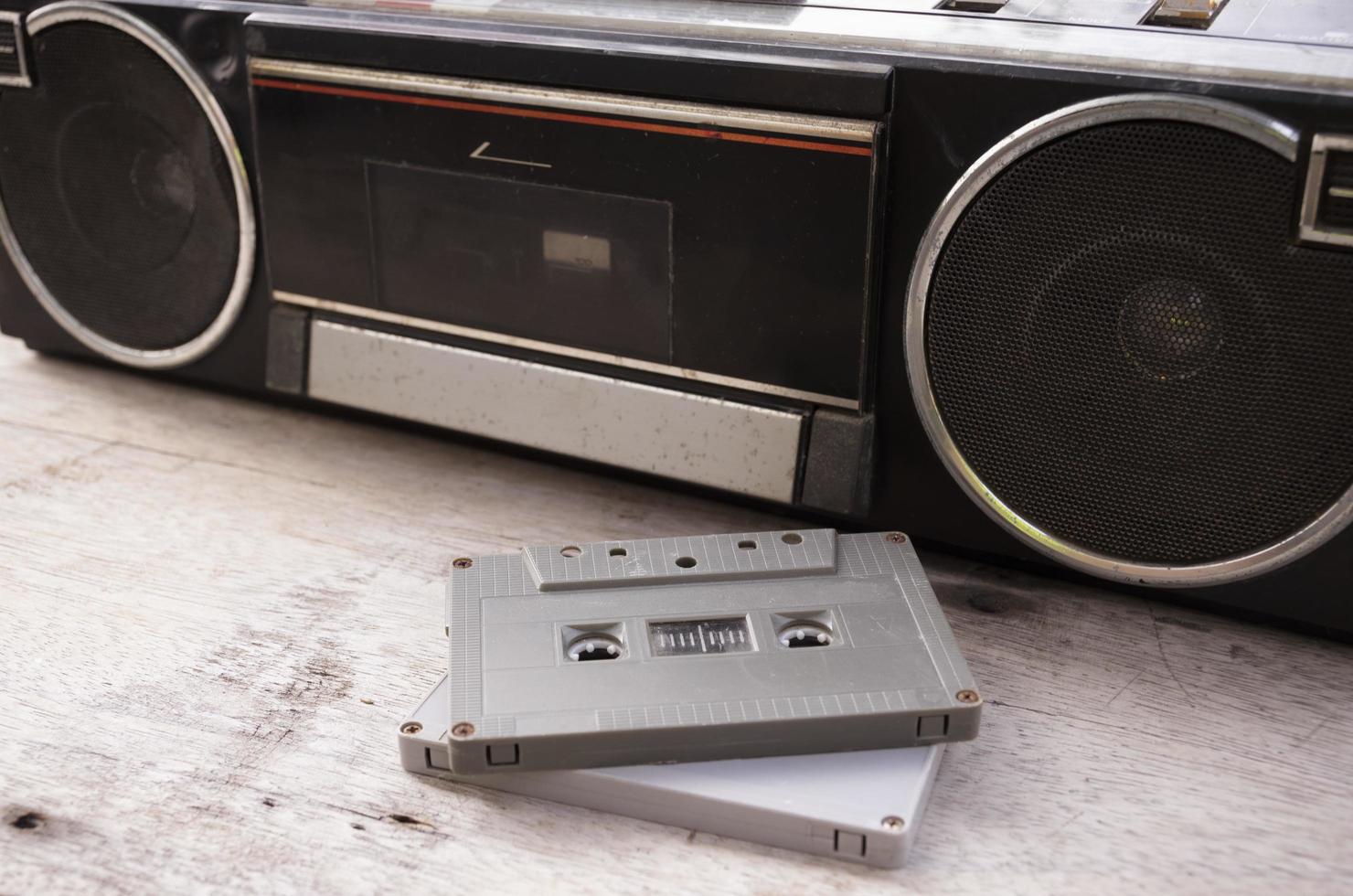 Retro radio and cassette tape on wooden floor photo