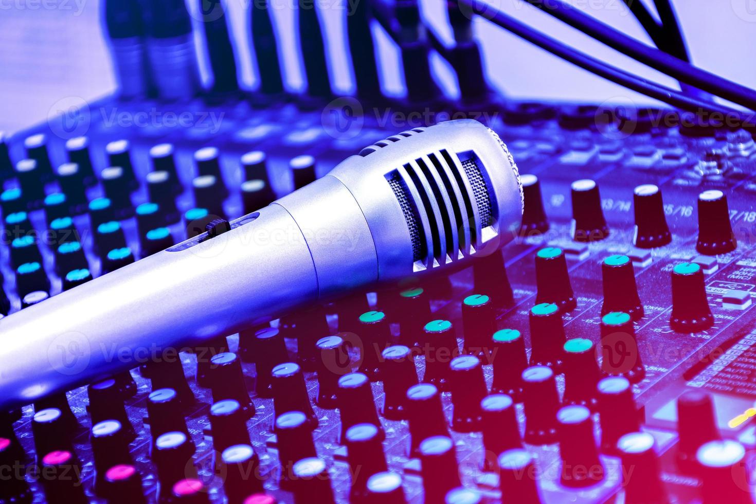 Sliver retro vintage microphone on console sound board mixer photo