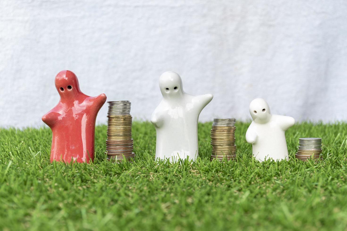 Mock up family statue and coins stack on grass floor with white background photo
