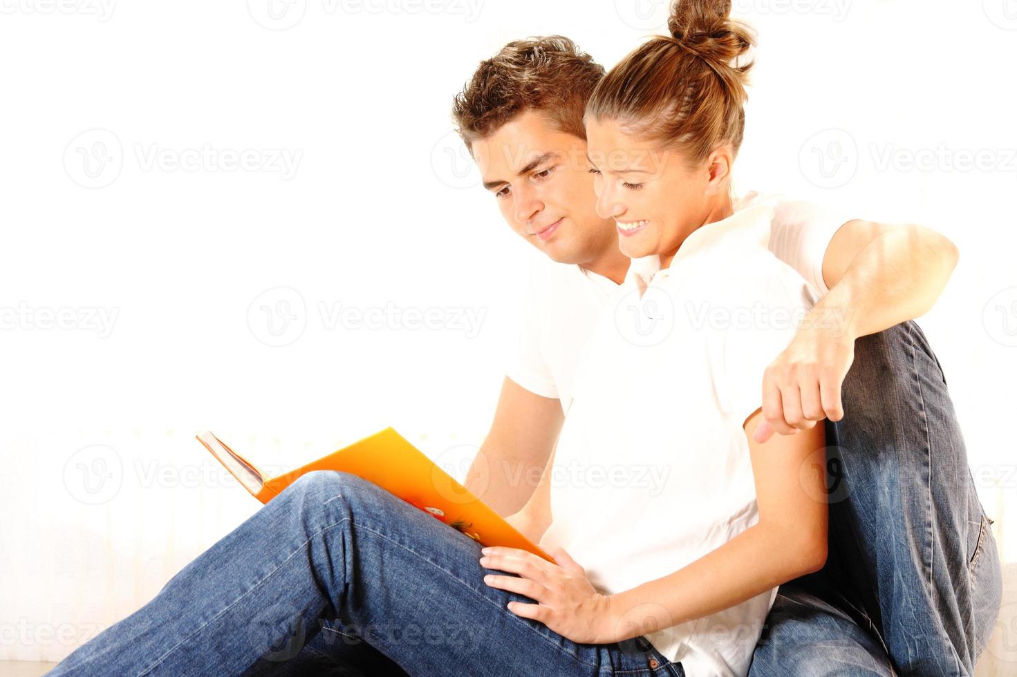 Young couple reading a book photo
