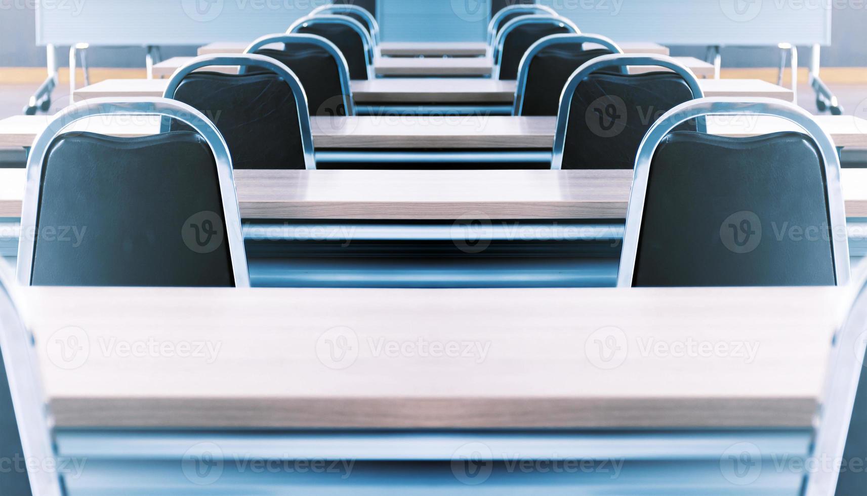Close up the chair in in seminar room with a speaker table in the middle of the stage photo